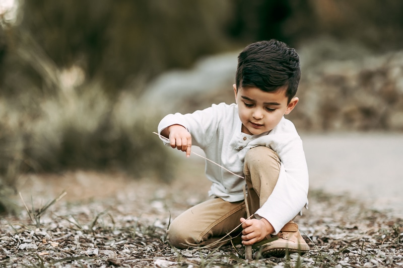 a boy playing in the dirt