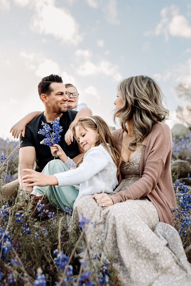 Family Photographer, Mom, dad, sister, and brother among the purple lupine meadow
