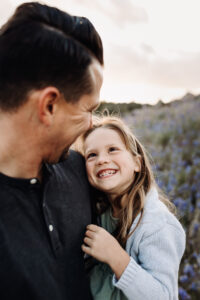 little girl smiling at dad at Folsom Lake