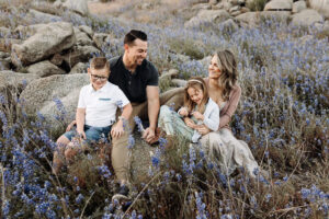family sitting in lupines at Beeks Bight